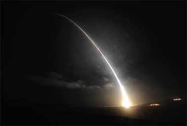 Rocket streaking through dark sky.