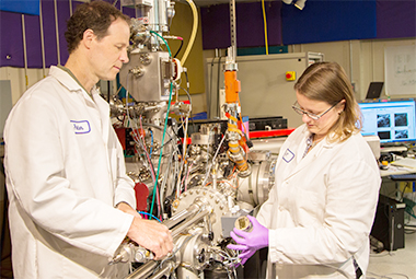 Livermore researchers Peter Weber and Jennifer Pett-Ridge prepare a sample for testing in the nanometer-scale secondary ion mass spectrometer (NanoSIMS), one of only a few such instruments in the world dedicated to isotope imaging in microbial biology and soils research.