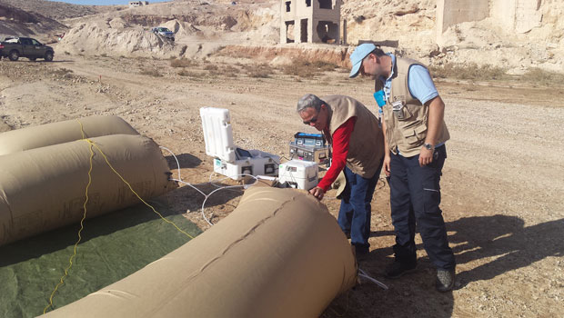 Environmental Report LLNL geophysicist Charles Carrigan (left), portraying a representative of the inspected state party during the Integrated Field Exercise in Jordan, evaluates background radiation levels in a storage bag containing subsurface gases captured by the Livermore-developed Smart Sampler. cover.
