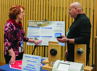 Administrator Shirley Davis discusses physical security as part of a security awareness campaign in December 2016 that included a traveling exhibit of interactive displays and information handouts.