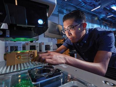 An LLNL engineer using a highly sensitive measurement system in the Polymer Production Enclave.