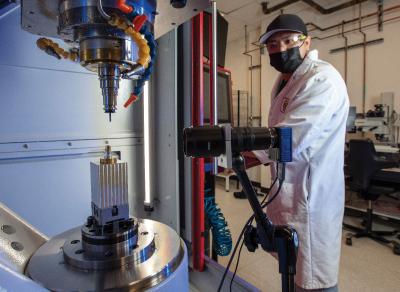 An LLNL precision machinist operates one of the new machines installed in the NIF target fabrication facility.