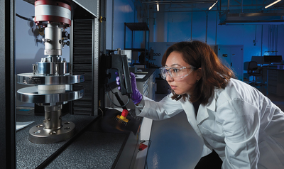 A scientist performs a nondestructive evaluation in the Polymer Enclave.