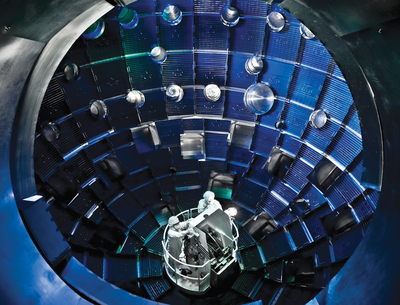 Technicians work inside the National Ignition Facility’s target chamber.