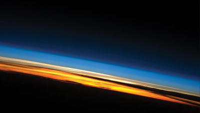 Layers of Earth’s atmosphere are shown in a view looking across Earth’s surface. (Photo courtesy of NASA.)